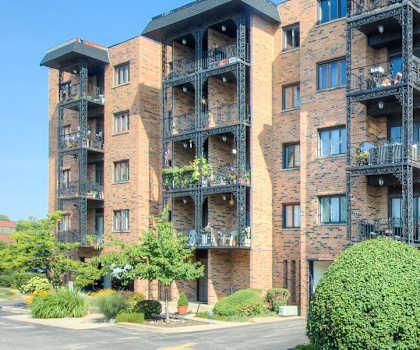 A large brick building with balconies and windows.