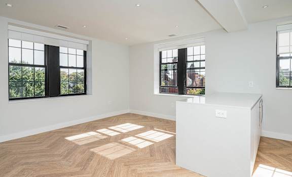 Refurbished historic windows and hardwood floors in this newly renovated apartment