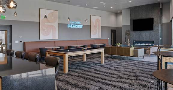 A modern lounge area with a fireplace and a TV. at SevenO2 Main Apartments, Salt Lake City