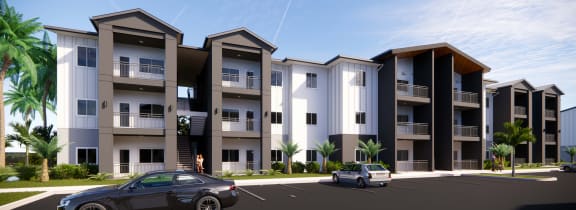 a rendering of an apartment complex with cars parked in front of it at Gibson Oaks, Lakeland, FL