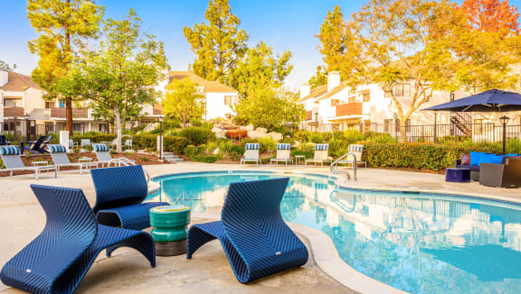 our apartments have a resort style pool with lounge chairs at Sendero Huntington Beach, Huntington Beach