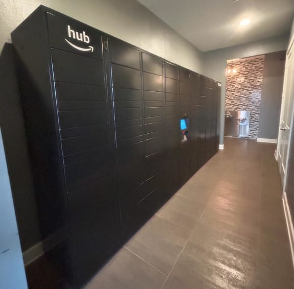 a long hallway with black lockers and a tv on the wall  at Watermark at Steele Crossing, Arkansas, 72703