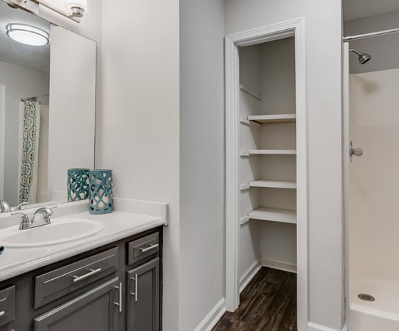 Spacious Bathroom with Built In Shelving and Large Vanity