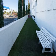 a white bench sitting on the side of a building at Warner Center Townhomes, California
