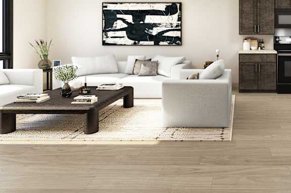 A modern living room with a white sofa, a wooden coffee table, and a white chair.