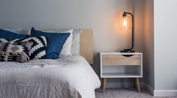 Clean Bed and Nightstand with Lamp