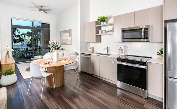 A modern kitchen with a dining table and chairs.