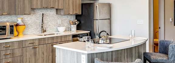 A kitchen with a counter and a chair.