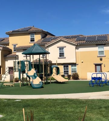 Landscaping of Tresor Apartments showing playground, sidewalk, and gazebo