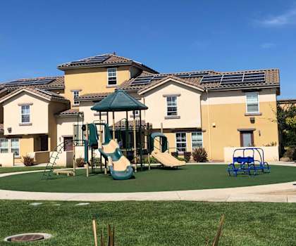 Landscaping of Tresor Apartments showing playground, sidewalk, and gazebo