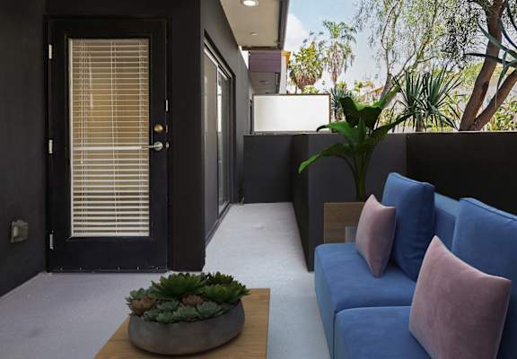 a living room with blue couches and a coffee table