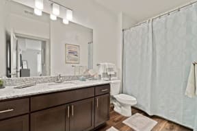 a bathroom with a toilet a sink and a mirror