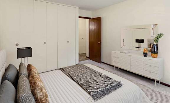 a bedroom with white walls and a large bed