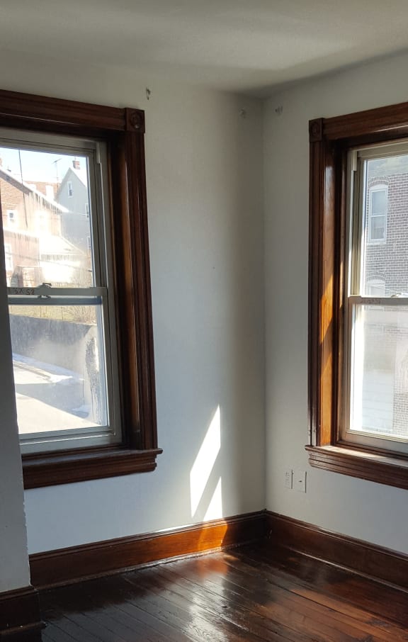 two windows in the ceiling of a home with wood paneling