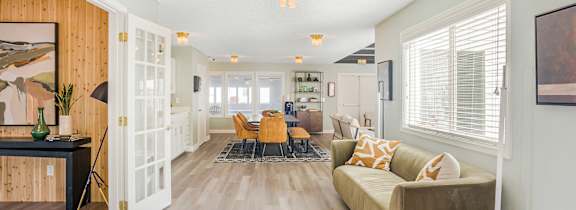 A large room with a couch, chairs, and a rug that says Concord Crossing.