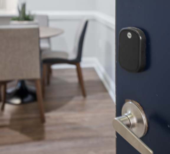 A dark blue door with a silver handle and a black lock.