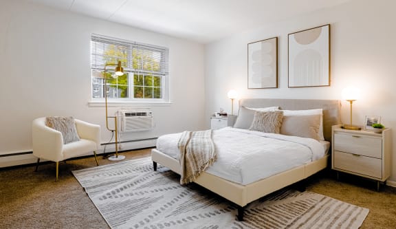 a bedroom with a bed and a chair and a rug at Chestnut Hill Village, Pennsylvania