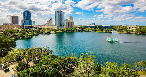 a boat on the lake with the denver skyline in the background at Paramount on Lake Eola, Florida, 32801