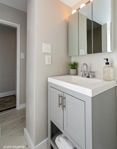 a bathroom with a sink and a mirror