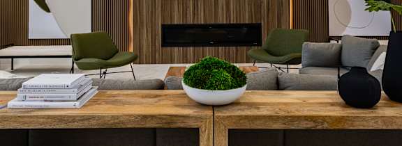 a living room with a couch and a table with a vase of flowers on it