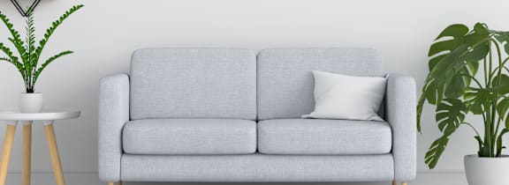 a white living room with a couch and plants at Crescent Pointe Townhomes, Stafford, VA 22554