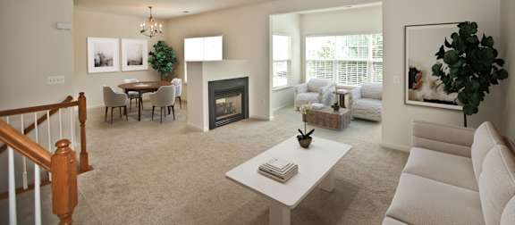 A living room with a fireplace and a dining table. at Barrington Park Apartments, Virginia, 20110