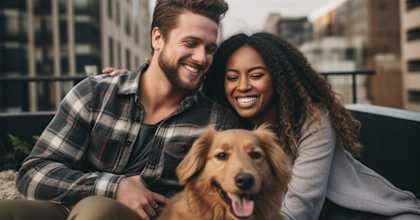 man and woman sitting on a couch with a dog