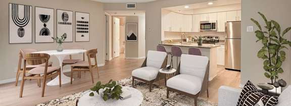 A modern living room with a dining table and chairs.
