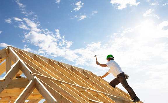 a construction worker working on top of a roof