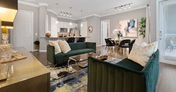 A living room with a green couch and a ceiling fan.