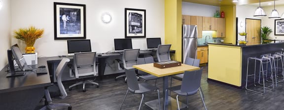 a large clubhouse kitchen and dining area with a fireplace and a table and chairs