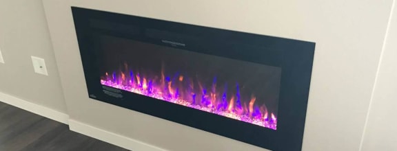 an electric fireplace in a room with a wooden floor