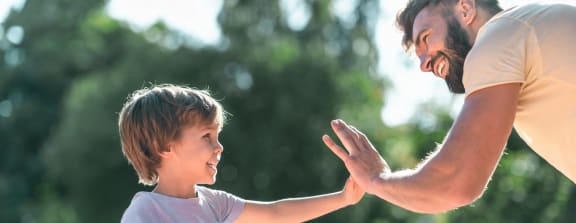 Father and Son Giving Each Other High Five