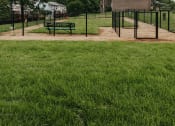 Thumbnail 27 of 29 - Fenced in Dog Park with benches at Woodridge Apartments in Randallstown, MD 21133.