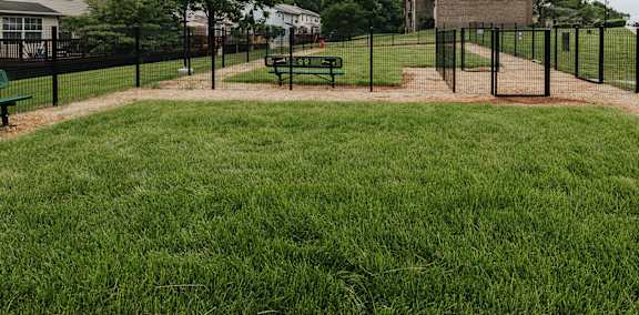 Fenced in Dog Park with benches at Woodridge Apartments in Randallstown, MD 21133.