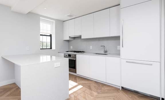 Dishwasher, gas range, large fridge and microwave in a sleek newly renovated kitchen