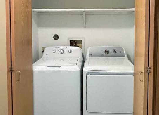 a laundry closet with a washer and dryer in it