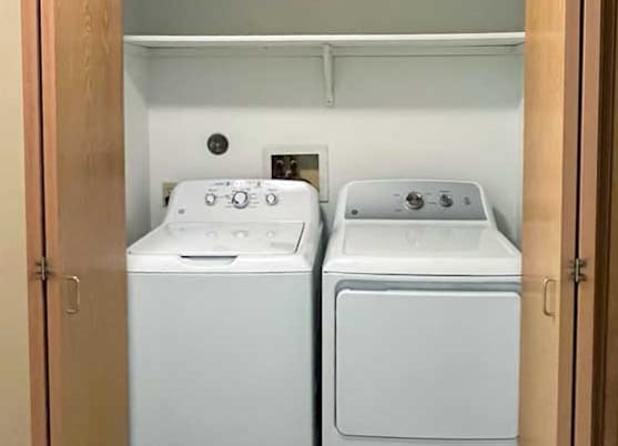 a laundry closet with a washer and dryer in it