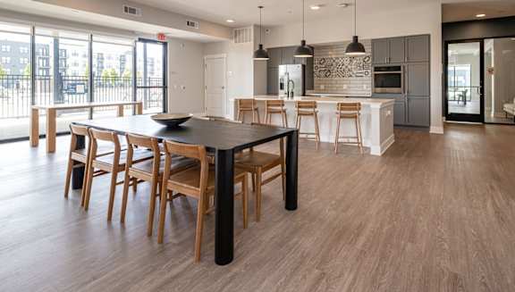a kitchen and dining room with a table and chairs