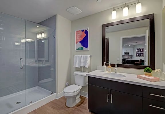 A bathroom with a toilet, sink, and shower.