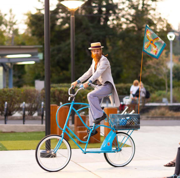 a statue of a man riding a blue bicycle