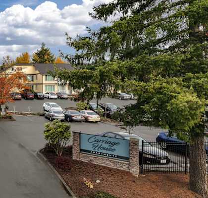 A street view of a residential area with a sign that reads "Crestwood.".