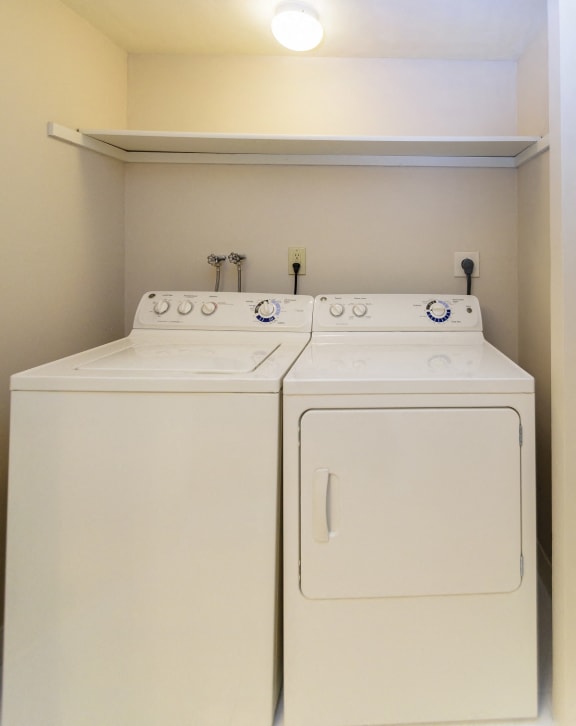 Spacious laundry room with full-size washer and dryer units at New Kent Apartments in West Chester, PA