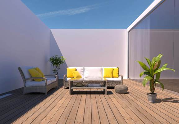 A wooden deck with two chairs and a table.