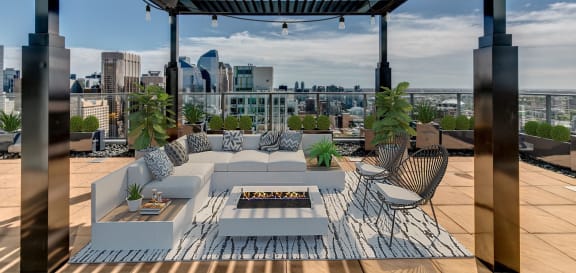 a roof terrace with furniture and a view of the city at Versus, Calgary, AB