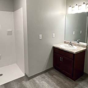 A bathroom with a toilet, sink, and shower.