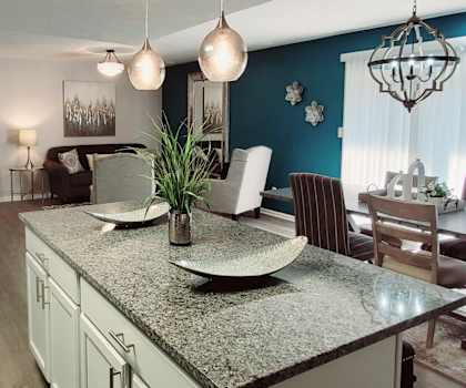 A kitchen with a table and chairs in the middle of the room.