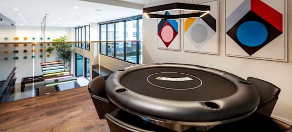 A black table with a white logo in the middle is in the foreground of the image.