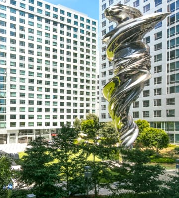 a large silver sculpture in the middle of a city