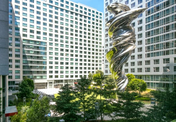 a large silver sculpture in the middle of a city